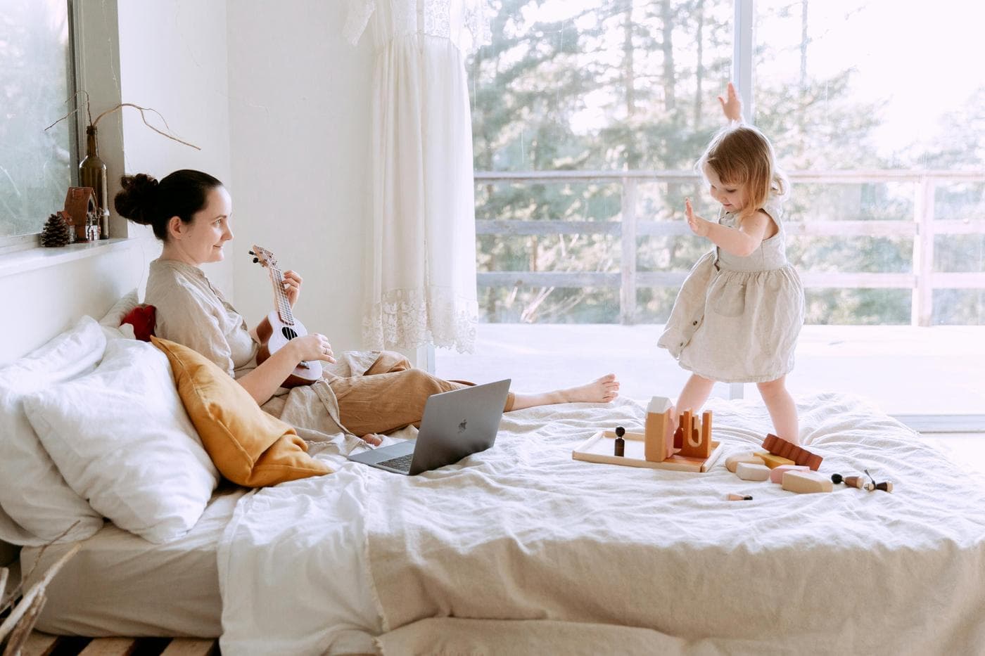 Parent and child in a bright bedroom setting